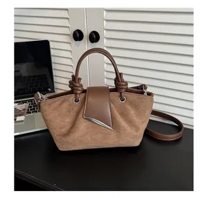 Detailed view of the brown retro suede women handbag featuring top handle and crossbody strap.