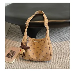Brown polka dot suede hobo bag detail, showcasing retro style and large capacity.