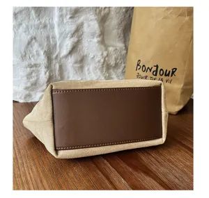 Close-up detail of retro suede handbag bottom, exquisite leather contrast, minimalist style.
