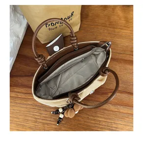 Detailed view of the vintage suede tote bag interior lining and brown leather handles.