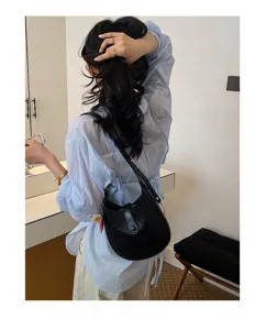 Classic black leather saddle bag for women, chic underarm shoulder bag for daily casual use.