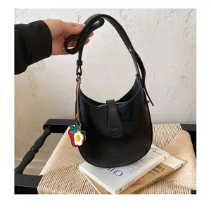 Black hobo shoulder bag for women, stylish minimalist PU leather saddle bag with cute charm.
