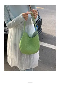Stylish green woven shoulder bag for women, chic intrecciato design casual commuter handbag.