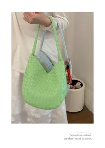 Woven shoulder bag detail featuring stylish green and blue underarm design for daily fashion.