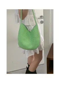 Green woven shoulder bag detail, stylish underarm bag design showcasing premium intrecciato texture.