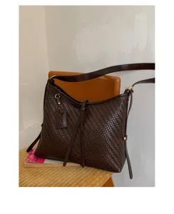 Dark brown woven vintage hobo shoulder bag for women, chic bucket design accessory.