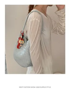 Light blue woven shoulder bag detail, stylish women's commuting handbag style.