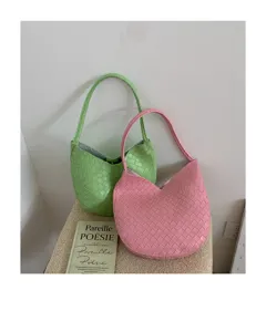 Elegant woven shoulder bag for women, stylish large capacity underarm handbag in pink and green.