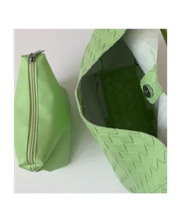 Light green woven leather shoulder bag with matching pouch, stylish everyday tote for women.