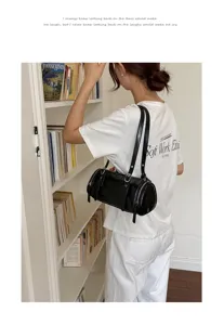 Bolso de hombro retro de charol negro para mujer, bolso de almohada cilíndrico chic minimalista.