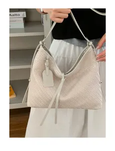 Detailed view of stylish woven underarm shoulder bag featuring retro texture details.