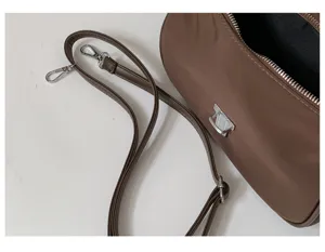 Minimalist nylon shoulder bag for women, chic brown underarm handbag, versatile daily purse.