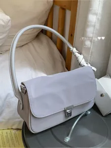 Minimalist nylon underarm shoulder bag for women, versatile daily handbag with lock.