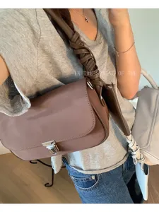 Chic brown underarm shoulder bag for women with woven strap and metal lock closure stylish