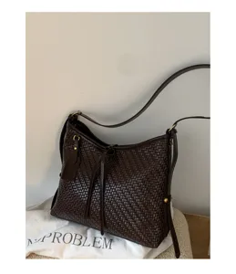 Retro woven bucket shoulder bag for women, chic dark brown leather underarm handbag daily use.