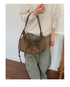 Brown suede hobo bag detail shot, vintage style shoulder bag for women, retro dumpling purse.