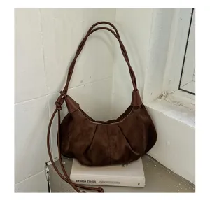 Brown suede shoulder bag detail view, vintage hobo purse with pleated design and strap.