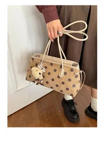 Suede shoulder bag for women with chic polka dot print and cute bear pendant charm accessory.