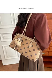 Detailed view of the stylish suede women's shoulder bag with chic polka dots and cute bear.
