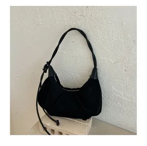 Minimalist black suede shoulder bag, retro underarm hobo dumpling bag for women's daily use.