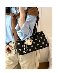 Women faux suede shoulder bag with polka dot print and cute bear pendant detail.
