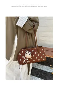 Brown suede shoulder bag detail, large polka dot print, cute plush dog pendant accessory.
