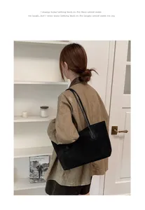 Detailed view of the elegant retro suede underarm shoulder bag worn by a model in a room.