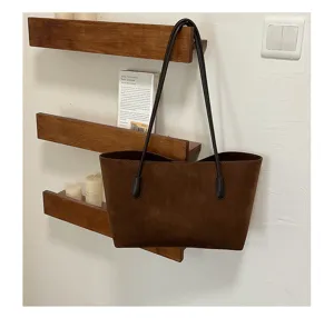 Detail view of retro brown suede tote bag, minimalist shoulder hobo bag for women.