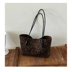 Detail view of the vintage faux suede leopard print tote bag, displaying fine texture and straps.