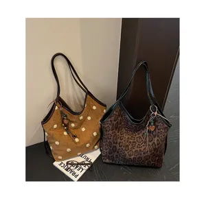 Retro plush polka dot and leopard print suede shoulder tote bags detail, vintage style.