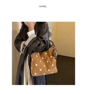 Vintage brown suede shoulder bag with white fuzzy polka dots, stylish hobo tote for women.