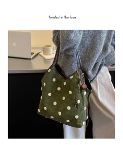Vintage velvet polka dot shoulder tote bag detail view with brown leather handles.