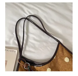 Detailed view of vintage brown plush polka dot suede underarm shoulder tote bag with leather straps.