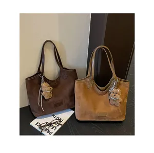Detailed view of retro large-capacity suede tote bags, minimalist chic solid color shoulder bag.