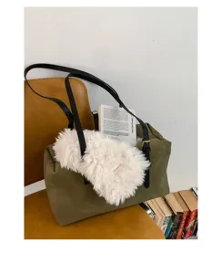 Dark green retro shoulder pillow bag detail, showing soft suede texture and chic plush charm.