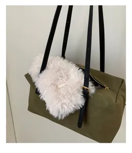 Detailed view of large capacity retro shoulder pillow bag with plush accessory and strap.