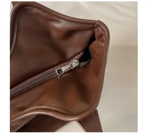 Minimalist brown leather tote bag detail, retro women shoulder underarm handbag.