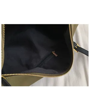 Interior detail view of the vintage style retro green shoulder bag, showing black lining zipper.