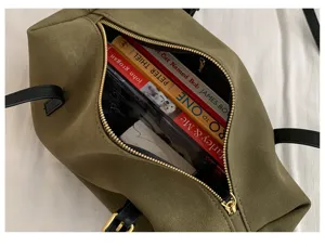 Detail view of the olive green vintage tote bag interior, showing large storage capacity and soft texture.