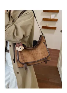 Detailed shot of the brown suede shoulder bag showcasing soft texture and stylish stitching.