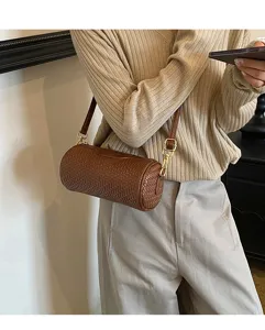 Brown woven cylinder shoulder bag for women, stylish retro barrel crossbody purse with strap.