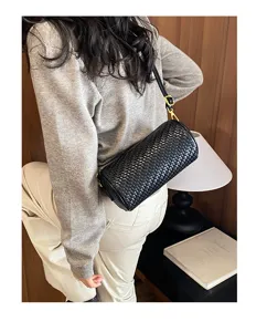 Retro textured women's woven cylinder shoulder bag, stylish crossbody pillow bag for daily wear.