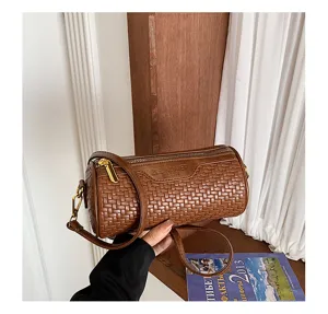 Retro brown woven cylindrical shoulder bag with metal zipper, detailed barrel design for daily.