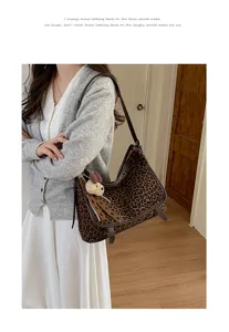 Chic leopard print shoulder bag for women, soft suede tote bag with brown leather strap detail.