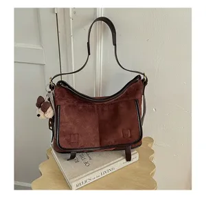 Women vintage brown suede shoulder bag, stylish soft PU leather trim handbag with cute charm.