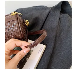 Brown woven cylindrical shoulder bag detail view, vintage leather barrel pillow bag for women.