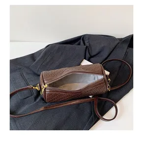 Brown woven barrel crossbody bag vintage stylish cylindrical shoulder bag for women.