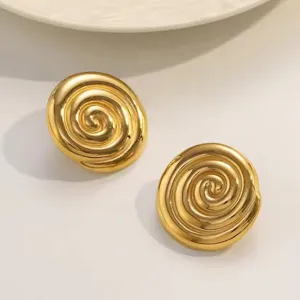 Detailed close-up of gold-plated spiral stud earrings, featuring a chic conch design.