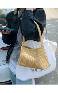 Stylish yellow woven underarm bag for women, chic leather shoulder handbag for daily commute.