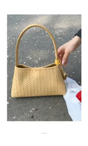 Detail view of stylish woven leather shoulder bag, trendy yellow hobo bag for daily commute.